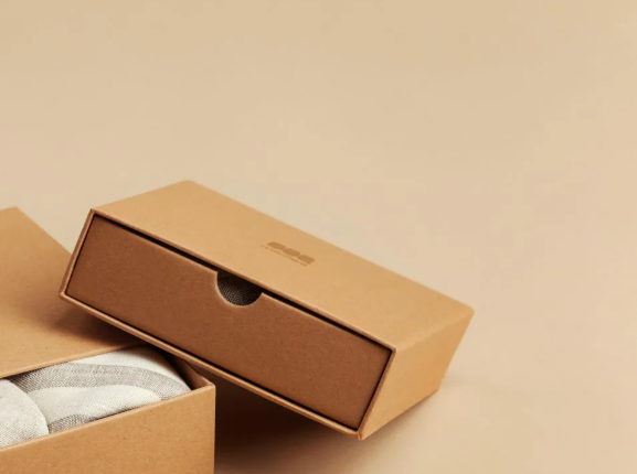 Production line view with workers assembling cartons